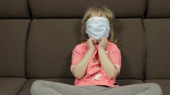 Concept of Sick Little Girl Wearing a Medical Mask. Quarantine. Making Faces