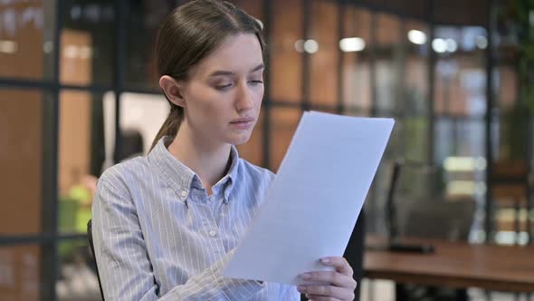 Young Woman Upset By Reading Documents