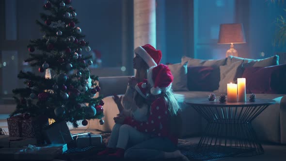 Mother and Daughters Clapping for Christmas Tree to Light Up