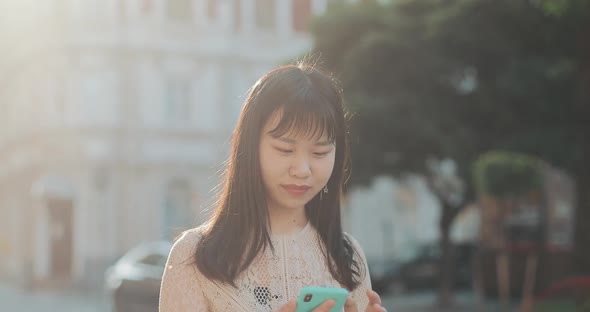 Close Up of Asian Girl Using Smartphone.