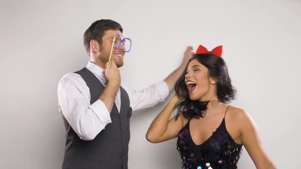 Couple with Party Props Having Fun and Dancing