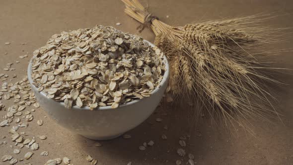 Slow motion of oatmeal falling into a bowl. Whole grain cereals