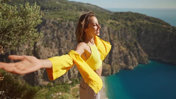 Side View Happy Traveler Freedom Filling Woman with Open Arms Laughing and Enjoying Mountains View