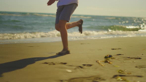 Barefoot legs running on sand