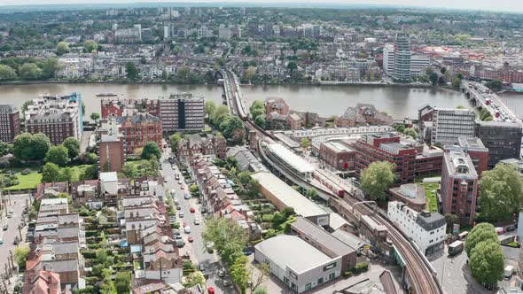 Stationary aerial drone shot of Putney bridge Tube station West London