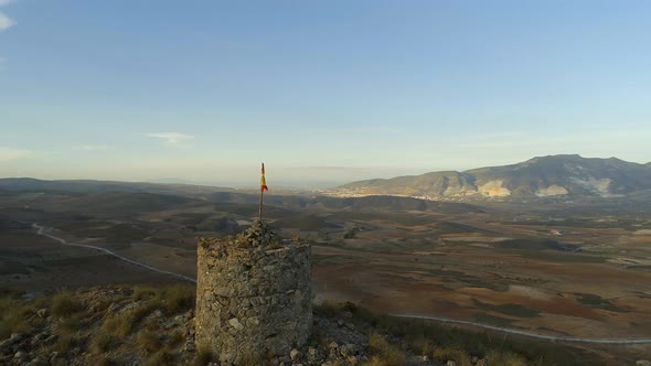 Circling an Old Abandoned Lookout Tower with a Spanish Flag