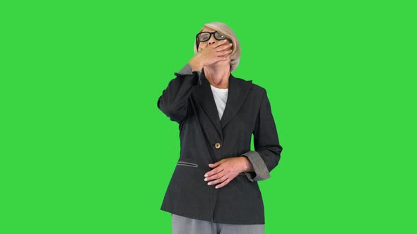 Tired Bored Attractive Senior Woman Wants To Sleep on a Green Screen Chroma Key