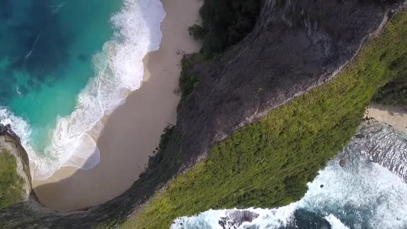 Calmer aerial view flight drone shot from above Untouched nature big wavesKelingking Beach at Nusa