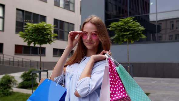 Girl Holding Colorful Shopping Bags, Rejoicing Discounts in Fashion Store, Enjoying Shopping in Mall