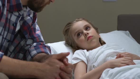 Worried Father Touching Daughter Forehead Measuring Temperature, Sick Child