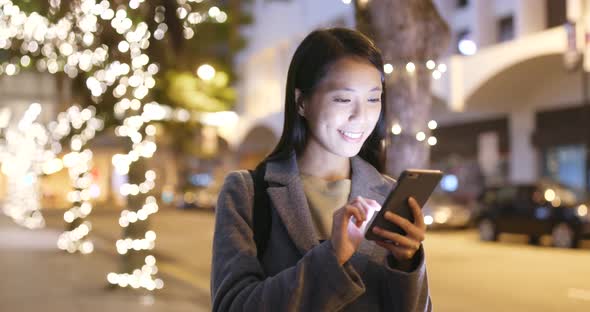 Woman use of cellphone at night