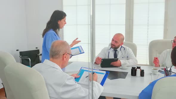Medical Assistant Using Clipboard Presenting Disease Development