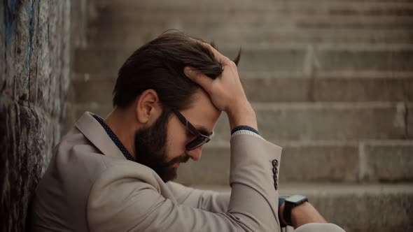 Frustrated Businessman Sitting On Steps. Remote Work Overtime. Workaholic Depressed At Deadline.