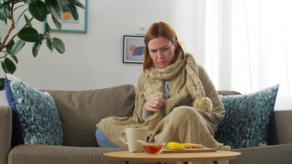 Sad Sick Young Woman Drinking Hot Tea at Home