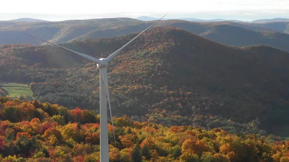 Windmill turbine wind farm aerial during beautiful autumn leaf season