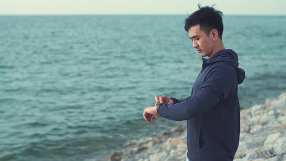 Attractive fitness man wearing sportswear standing outdoors.