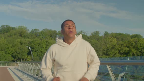 Motivated Sporty Fit African American Male Jogger Practicing Morning Run at Dawn