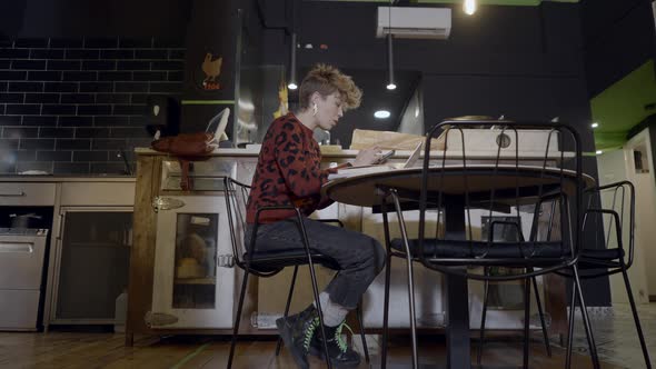 Ground View Pushout of Young Woman Using Computer in Empty Restaurant