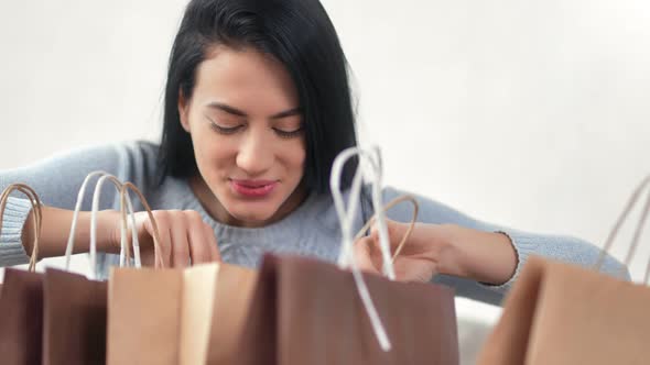 Asian Female Smiling Open Shopping Bags with Gifts Isolated