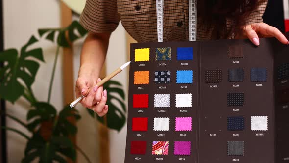 Dressmaker Woman Working with Color Samples for Selection New Clothing Collection