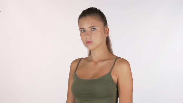 Young Woman Suffering From Elbow Injury, Looking To the Camera