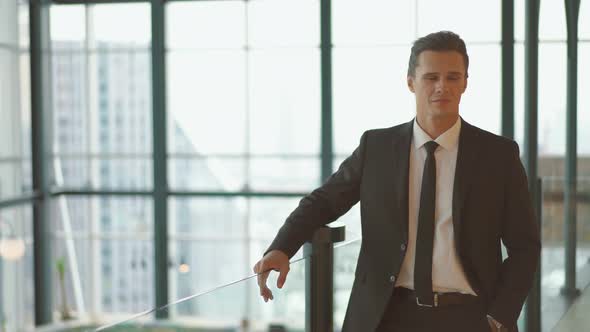 Portrait of young confident successful businessman looking at camera in workplace,Happy business man