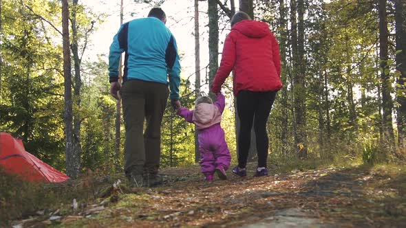 American Happy Family with Child Walking Together in Forest in Fall Season