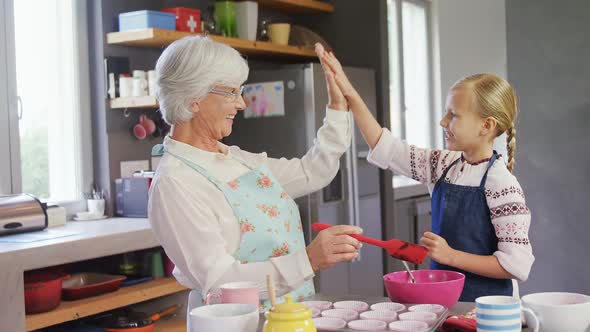 Grandmother and granddaughter giving high five 4k