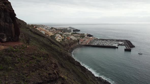 Aerial drone view on Puerto de Santiago town as seen from Los Gigantes cliffs in Tenerife, Canary Is