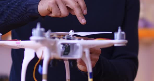 Male Hands Mount the Propeller on the Drone