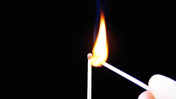 Lit Match and Flame on a Black Background and Then Goes Out Creating a Lot of Smoke