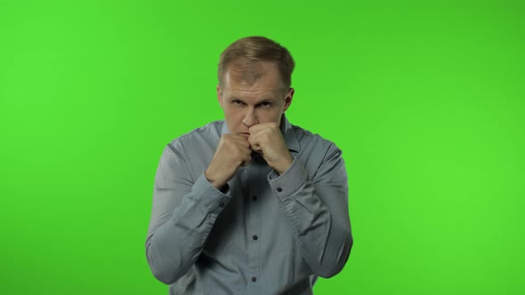 Funny Handsome Guy Trying To Fight at Camera, Boxing with Expression. Man on Chroma Key Background