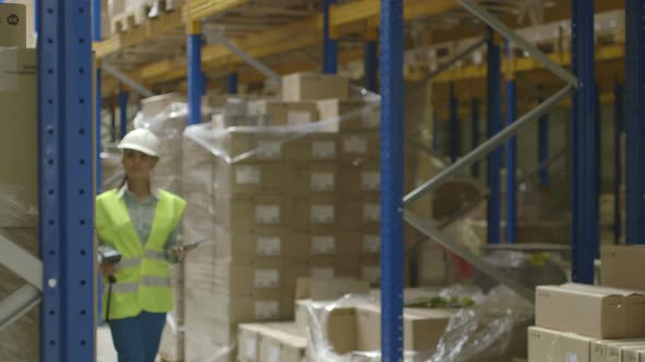 MS Young woman engineer using digital tablet and scanner in factory