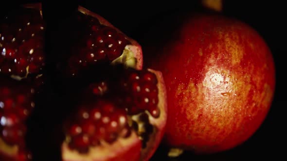 Two Bright Tasty Big Pomegranates on a Black Table