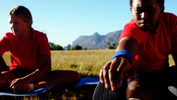 Trainer instructing kids while exercising in the boot camp