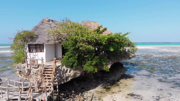 The Rock Restaurant in Ocean Built on Cliff at Low Tide on Zanzibar Aerial View