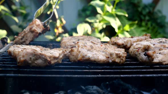 Frying Juicy Pieces of Fresh Pork Neck Steak Meat Prepared on Grill or Outdoor Barbecue Lattice