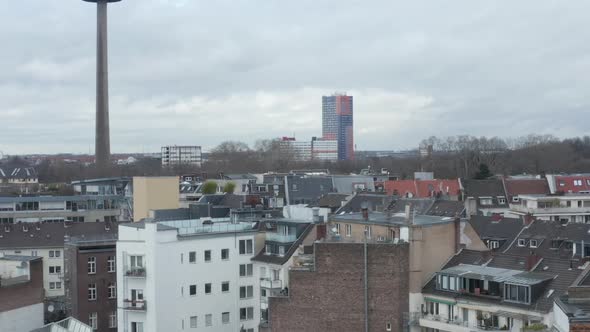 AERIAL: Low Shot Over Germany City Cologne with View of TV Tower on Cloudy Day 