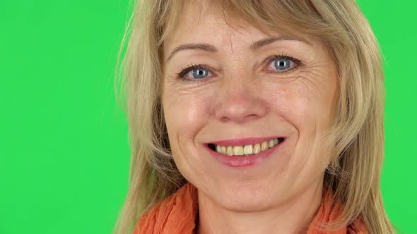 Middle Aged Blonde Woman Smiling While Looking at the Camera