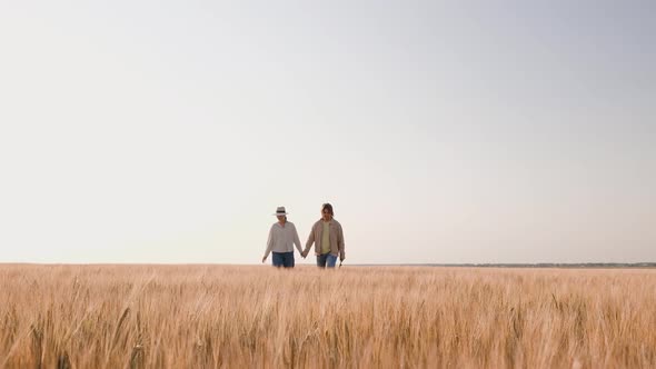 Young Farmers Examing Planted Wheat in the Fields