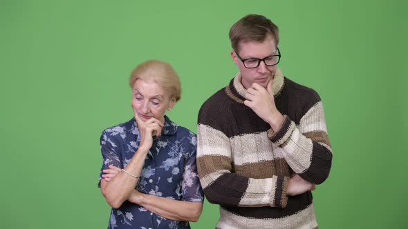 Serious Grandmother and Grandson Thinking Together