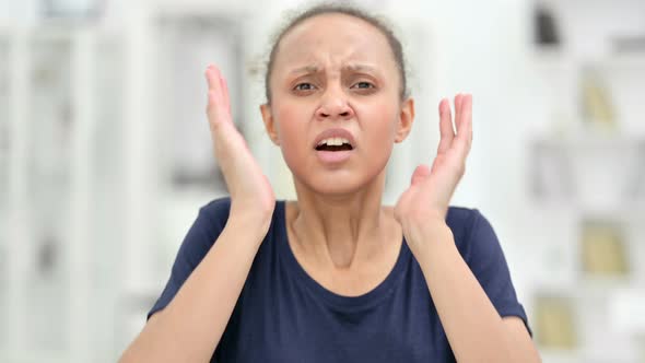 Portrait of Disappointed African Woman Reacting To Loss 