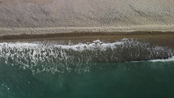 Aerial View From Above on Calm Azure Sea and Volcanic Rocky Shores