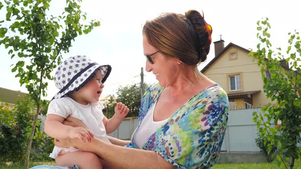 Baby girl on grandmothers hands, Grandmother with granddaughter, Generation connection