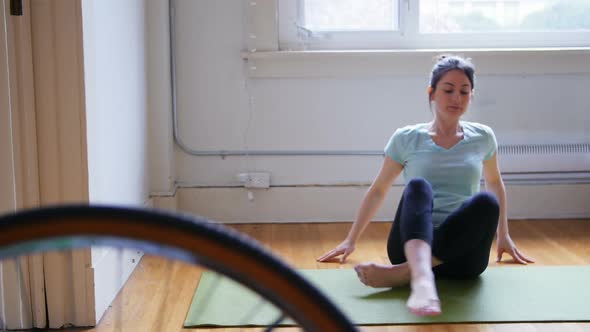 Young woman practicing yoga on exercise mat 4k