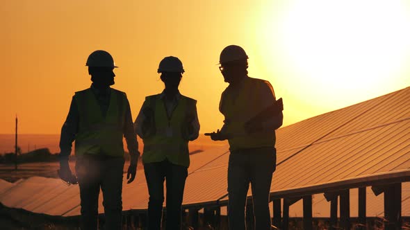 Team of Experts Are Walking Next To Outdoors Solar Panels