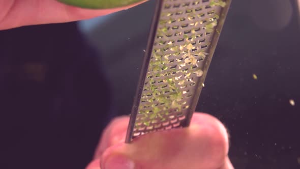 Cook grating fresh lime in kitchen