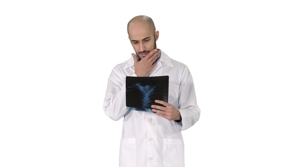 Doctor examining a lung radiography while walking on white