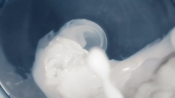 Milk Stream Flows Through the Bottle and Runs Outside in Slow Motion, Macro Video From Inside the