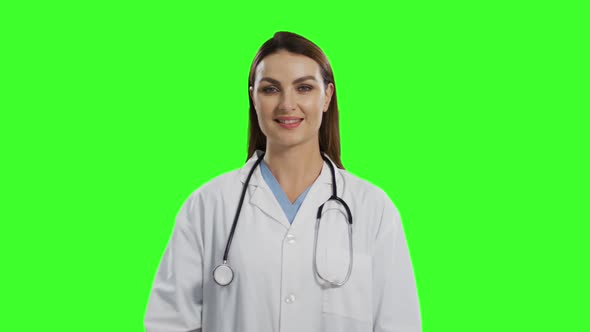 Caucasian female doctor on green screen background